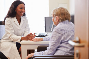 Doctor seeing patient- Cancer Insurance blog featured image