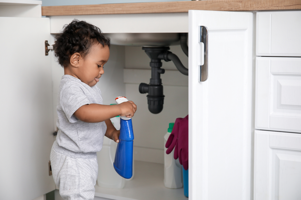 Child playing with cleaning product- Household Poison blog featured image
