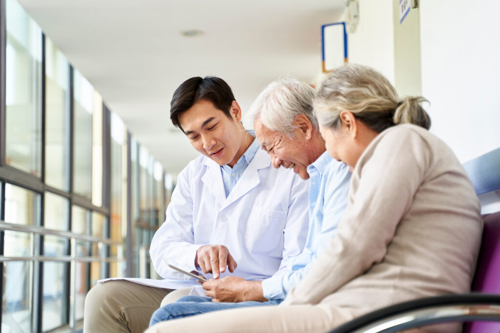 Image of an older couple filling out a form with a doctor- Medicare Advice blog featured image