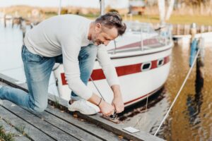 Man untying a boat from a dock- Boat Insurance blog featured image