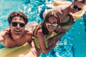 3 young adults enjoying a pool- Pool Safety blog featured image