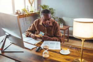 Image of an older man signing up for medicare- Medicare Enrollment blog featured image