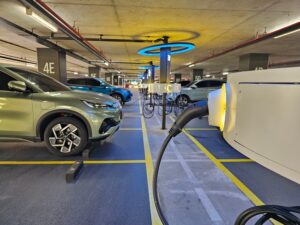 Electric vehicle charging station in a parking structure- EV Charging Safety blog featured image