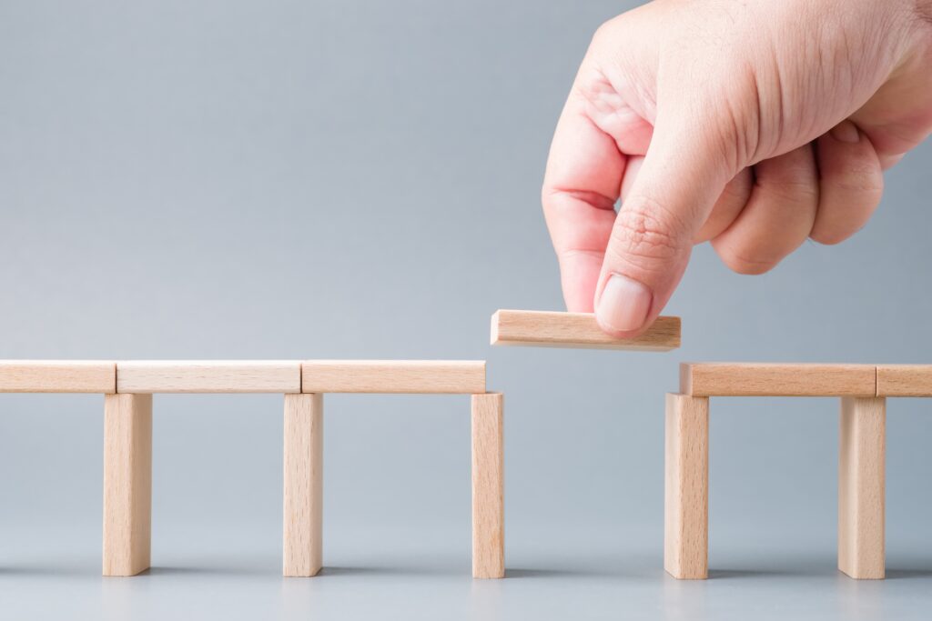 Putting the final piece in a bridge of blocks- Personal Insurance Coverage Gaps blog featured image