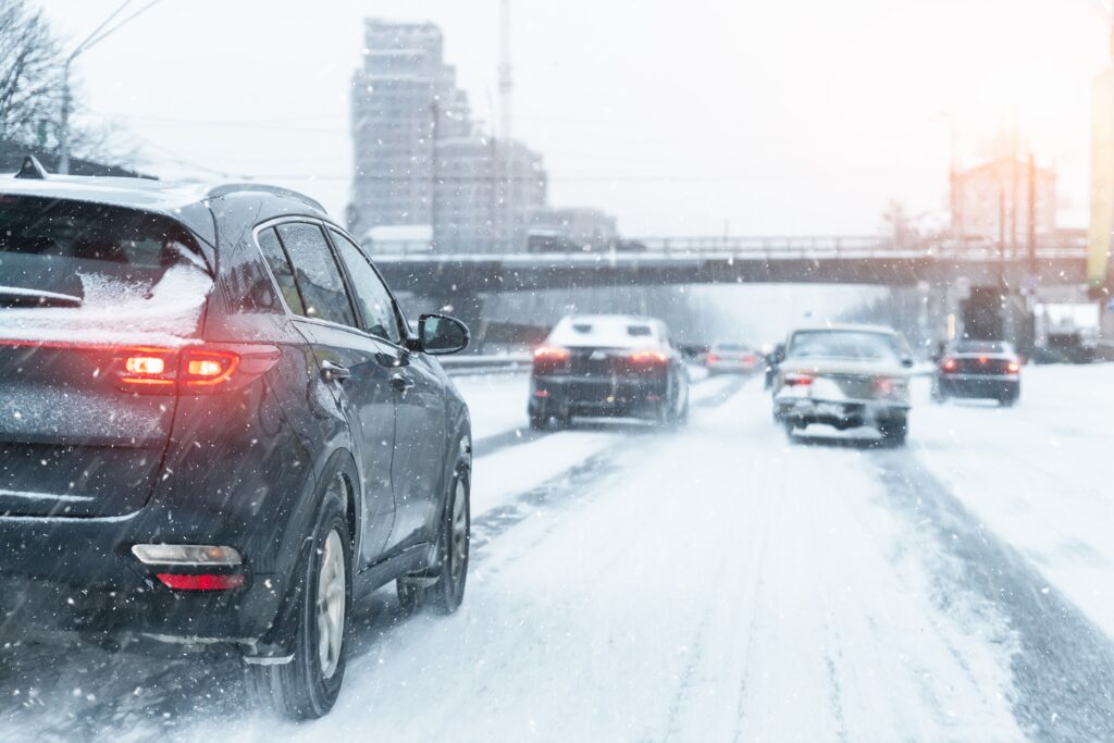 Image of cars on a snowy road: How to Drive in Snow blog featured image